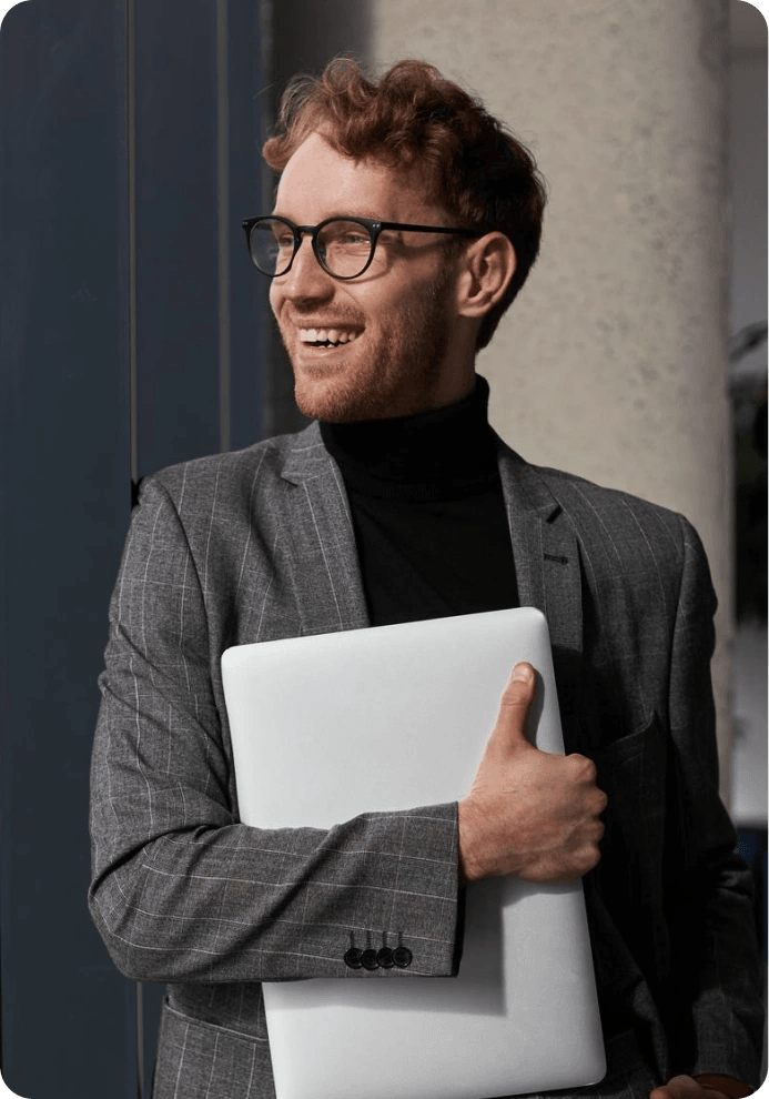 Young professional holding a laptop