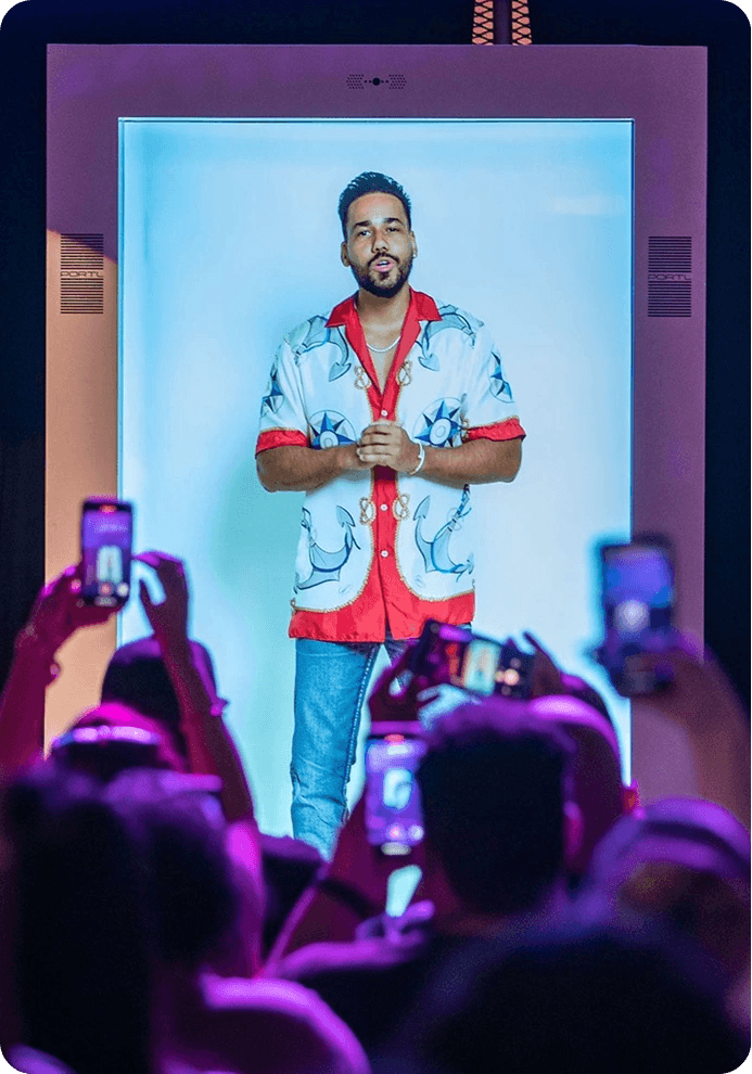 Performer shown in a Transcend holographic display booth before a crowd