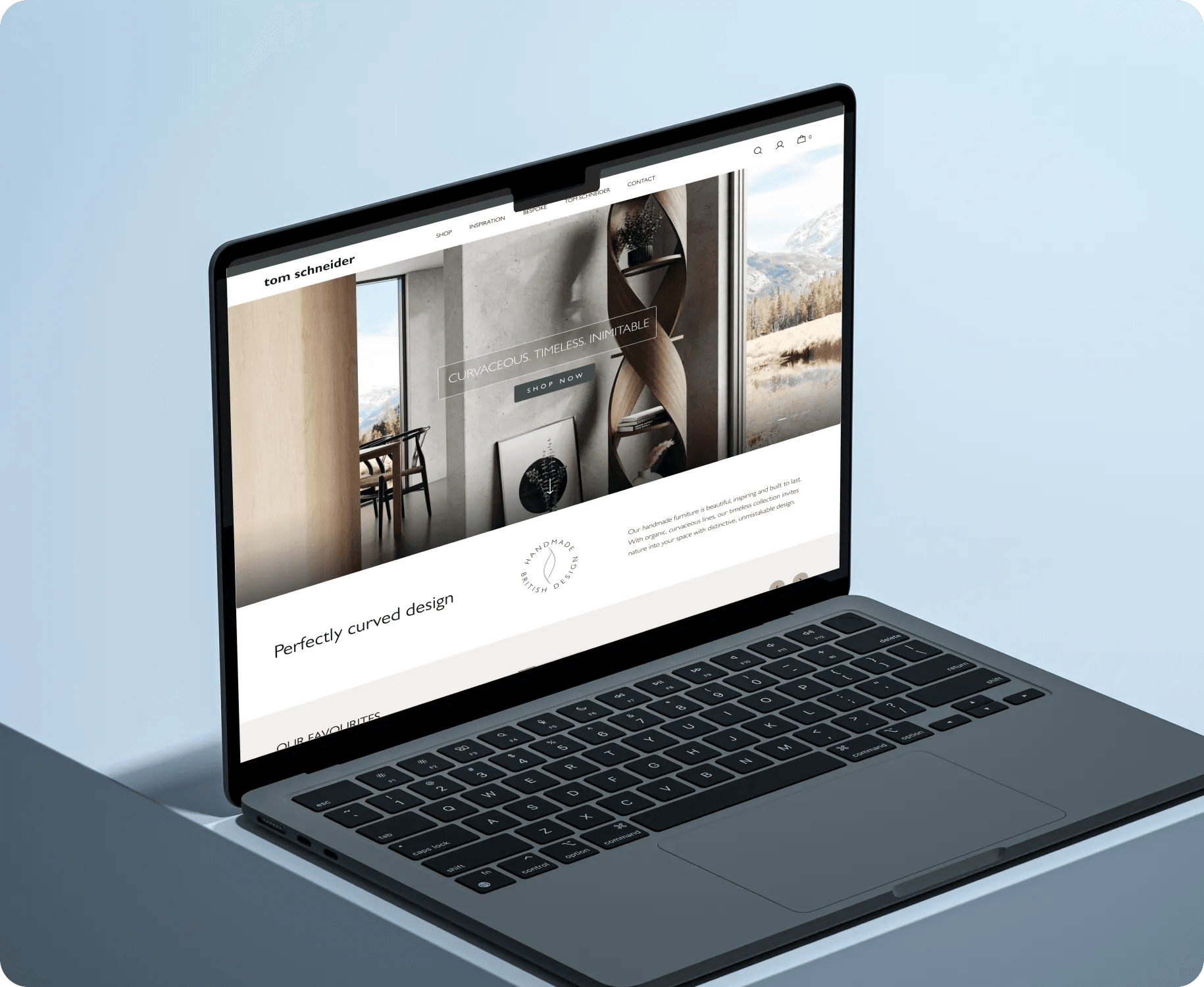 Tom Schneider furniture store on a laptop, showing a curved designer shelf.